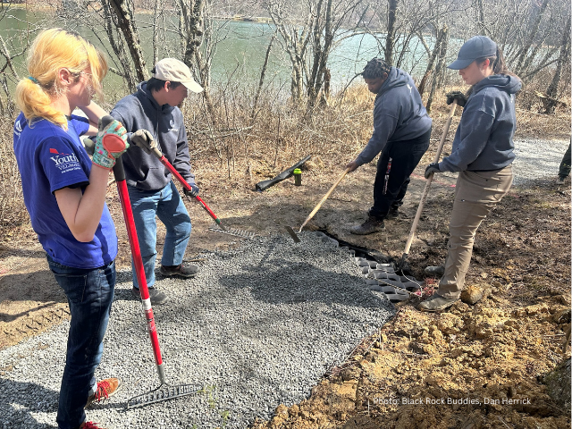Volunteers distributing gravel on the Lake Trail.
