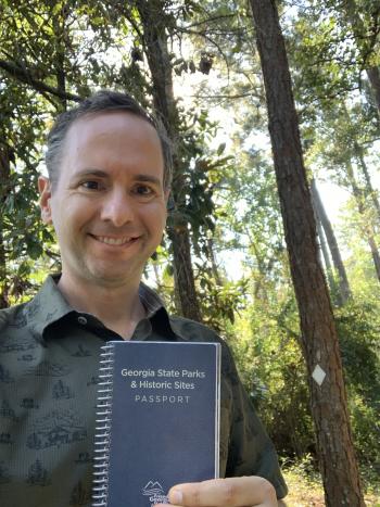 Garth at Georgia State Parks holding his Passport