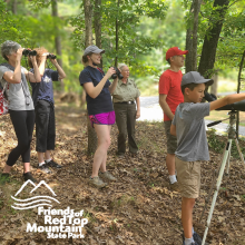 Park guests gathered with binoculars at Red Top Mountain State Park